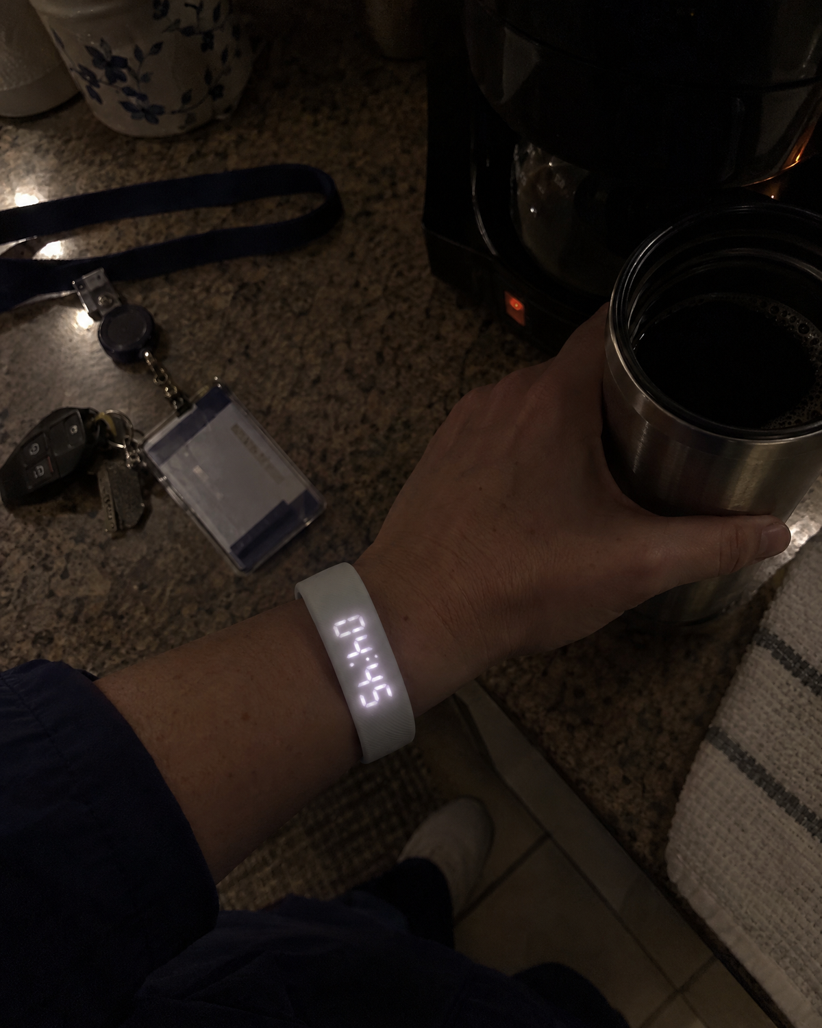 Nurse checking the Nemi band at 4:45 a.m. while holding a travel mug