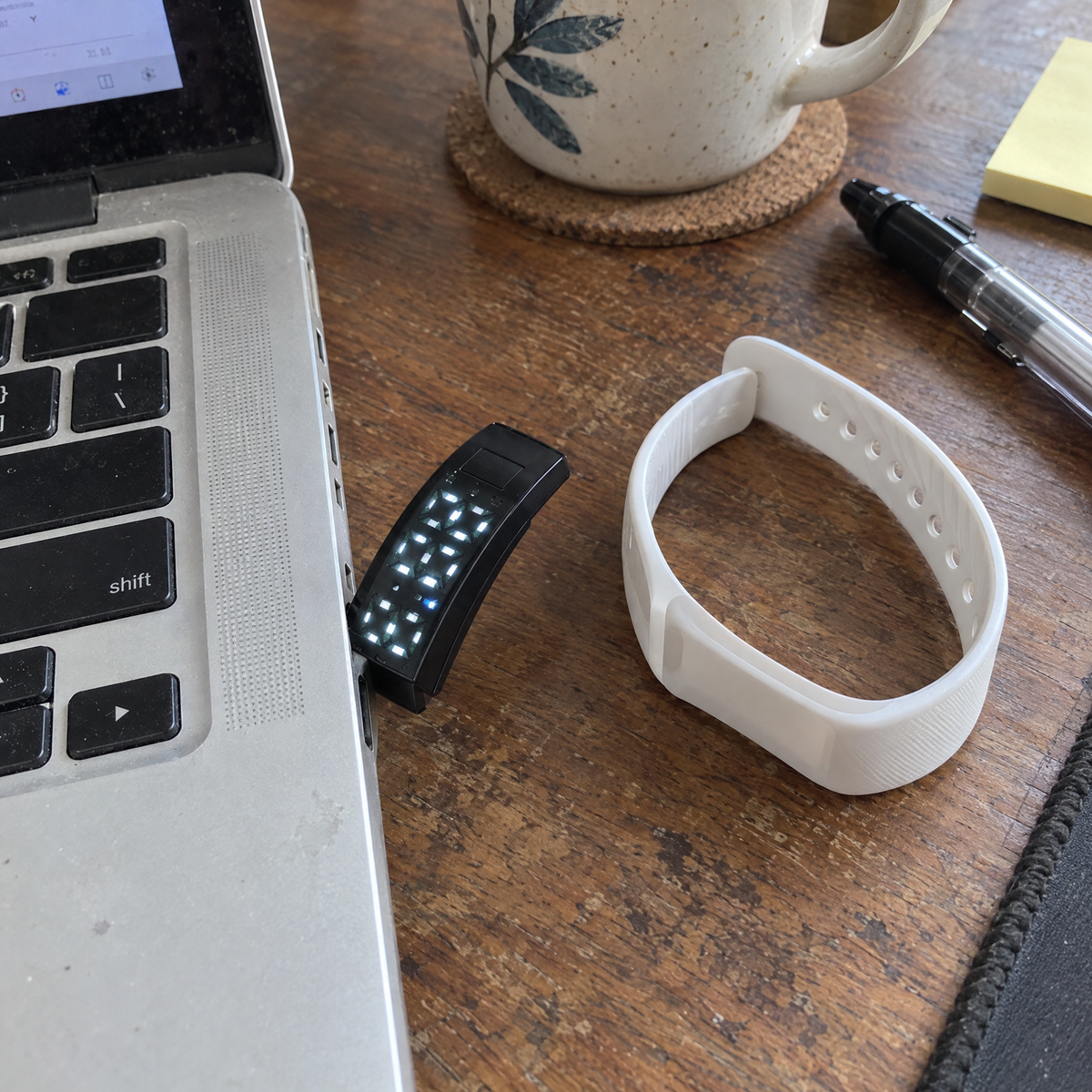 Nemi charging: the display taken out of the strap and plugged into a laptop's USB port