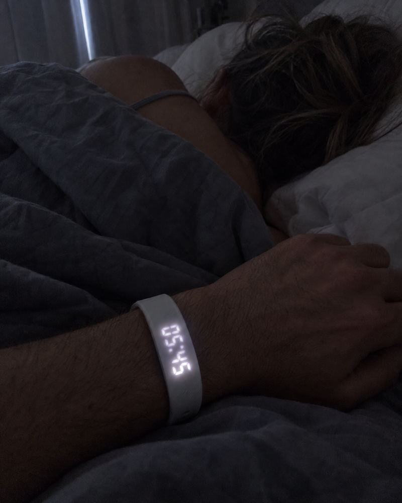 Man's wrist with the Nemi band at 5:45 a.m. while his partner sleeps