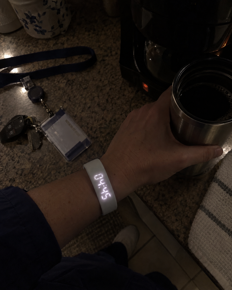 Nurse checking the Nemi band at 4:45 a.m. while holding a travel mug